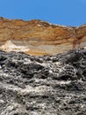 Rocky coast of the black sea. Profile cliffs made up of layers of different rocks