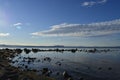 Rocky coast and the blue sea on a cloudy day Royalty Free Stock Photo