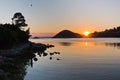 Rocky coast and calm water of Panormos bay at sunset, Skopelos island