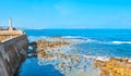 The rocky coast of Chania with medieval breakwater and Venetian lighthouse, Crete, Greece