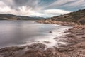 Rocky coast of Corsica and snow capped mountains Royalty Free Stock Photo