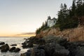 The rocky coast of Maine and the Bass Head Harbor Lighthouse at sunset in summer Royalty Free Stock Photo