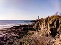 Rocky Coast of Maine with Portland headlight in the Distance Royalty Free Stock Photo