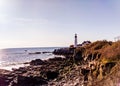 Rocky Coast of Maine with Portland headlight in the Distance Royalty Free Stock Photo