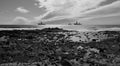 Rocky coast, oil rigs and cloudy sky