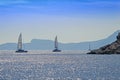 Rocky coast and sailing catamarans, Aegean sea