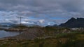 Rocky coast in south of village HenningsvÃÂ¦r, AustvÃÂ¥gÃÂ¸ya, Lofoten, Norway with football field, drying racks for stockfish.