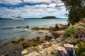 Rocky coast and view of cruise ship and island in Frenchman Bay Royalty Free Stock Photo