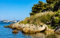 Rocky coast with woods of Ile Saint Honorat island of Abbaye de Lerins monastery offshore Cannes at French Riviera in France