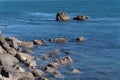 Rocky coastline with blue sea around Base Track Mount Maunganui