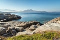 Rocky coastline of Corsica with citadel of Calvi in the distance