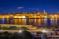 Rocky coastline of Malta and the architecture of Valletta city at night Royalty Free Stock Photo
