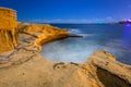 Rocky coastline of Malta at night illuminated by moonlight Royalty Free Stock Photo