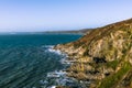 Rocky coastline and ocean waves in Cornwall, UK Royalty Free Stock Photo