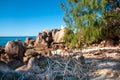 Rocky coastline with red granite rock formation in a wild beach Royalty Free Stock Photo