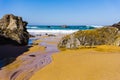 Rocky coastline of sandy Adraga beach, Portugal Royalty Free Stock Photo