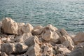 Rocky coastline. Sharp stones, rocks with sea water in background.