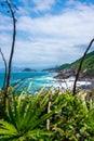 rocky coastline with turquoise-green water, green slopes and an absolutely blue sky Royalty Free Stock Photo