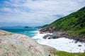 rocky coastline with turquoise-green water, green slopes and an absolutely blue sky Royalty Free Stock Photo
