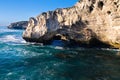 Rocky cove and ocean wave crashing into an eroded arch Royalty Free Stock Photo