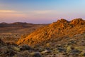 Rocky desert at dusk, colorful sunset over the Namib desert, Namibia, Africa, glowing rocks and canyon. Royalty Free Stock Photo