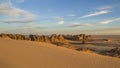 Rocky Desert Landscape of Tassili Of Hoggar in a cloudy sunset- Tin Akachaker