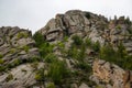 Rocky foothill with the clouds and blue sky in the background. Rock mountain in Mongolia on a cloudy day