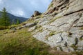 Rocky foothill with the clouds and blue sky in the background. Rock mountain in Mongolia on a cloudy day