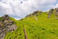 rocky formations on the steep grassy slopes of pikui mountain