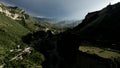 Rocky green mountains on cloudy sky background, aerial view. Action. Mountain range covered by greenery, New Zealand. Royalty Free Stock Photo