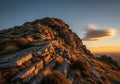 Rocky hillside in warm sunset light, with layered stone formations Royalty Free Stock Photo