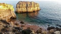 rocky island off the atlantic coast of portugal illuminated by the setting sun Royalty Free Stock Photo