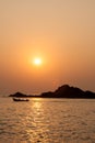 Rocky island silhouette and sunset