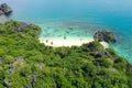 Rocky island with a white sandy beach, top view. Aerial top view of ocean waves, beach and rocky coastline and beautiful forest Royalty Free Stock Photo