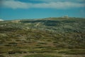 Rocky landscape with bushes and domes of an old radar station Royalty Free Stock Photo