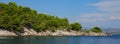 Rocky limestone coast of the Adriatic Sea covered with pine forest. Croatia coastline Royalty Free Stock Photo