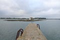 Rocky in the middle of the lake and the house, the dock is great , misty england