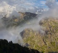 rocky mountain chain in dense clouds