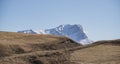 Rocky mountain with layered sharp slopes and snow on them and cliffs made of stones Royalty Free Stock Photo