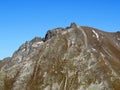 Rocky mountain peak Piz Murterchoembel (2998 m) in the massif of the Albula Alps above the Swiss road pass Fluela Royalty Free Stock Photo