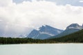 Rocky mountain peaks towering over evergreen forest and lake