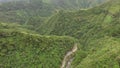 Rocky mountain rugged winding road replete with natural grown trees.