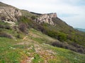Rocky Mountain, sloping mountain ridge at spring. The forest covers the hills and hiking trail with people. Crimean mountains Royalty Free Stock Photo