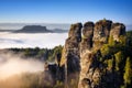 Rocky mountain view during autumn season. Foggy sunrise at Bastei, Germany Royalty Free Stock Photo