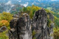 Rocky mountain view during autumn season. Foggy sunrise at Bastei, Saxon Switzerland, Germany Royalty Free Stock Photo