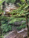 Rocky mountain wall with green trees in state park forest Royalty Free Stock Photo