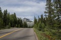 Rocky Mountains. asphalt mountain road on a sunny day. Road with yellow markings. Empty highway in Journey Royalty Free Stock Photo