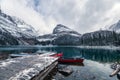 Rocky mountains with red canoe at wooden pier on Lake O'hara at Yoho national park Royalty Free Stock Photo