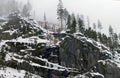 Rocky Mountainside with Foggy Trees