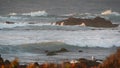 Rocky ocean coast, dramatic sea waves, Monterey beach, California, birds flying.